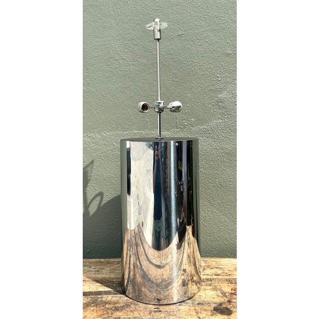 This monumental polished chrome cylinder lamp is a quintessential example of 1970s Modernist design. With its bold,...