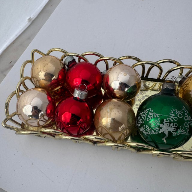Included are three 2 1/2” Shiny Brite ornaments that each have a stenciled mica design. The remaining dozen ornaments are...
