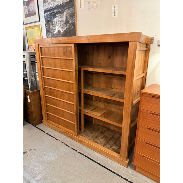 Design Plus Gallery presents a Vintage Tansu. This large wood cabinet offers a linear silhouette with paneled sides, and...