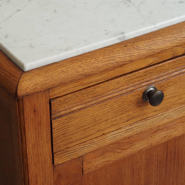 French Louis XV-style bedside table with a white marble top, dating from around 1900 to 1920. The galvanized legs and the...