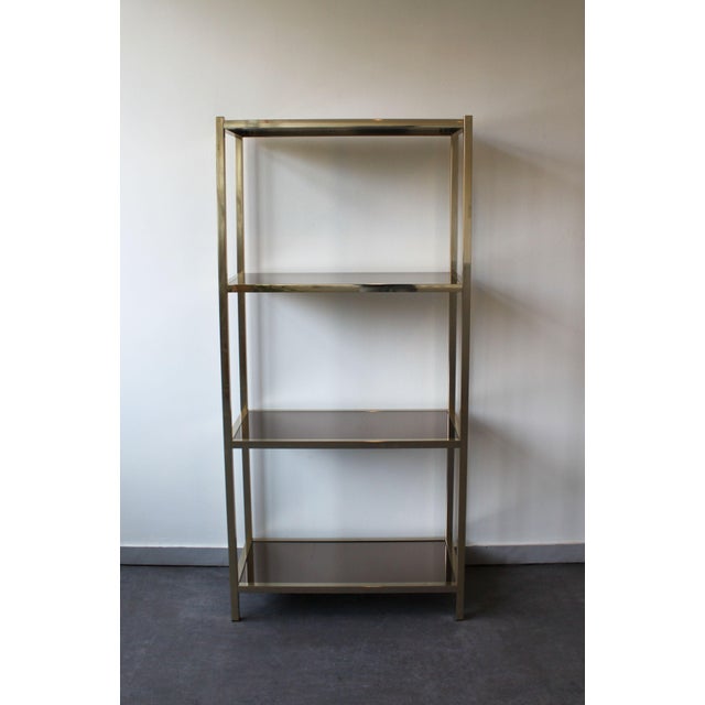 A stylish vintage shelf, perfect as a display piece in a living room or shop. It features a gold-tone metal frame and...