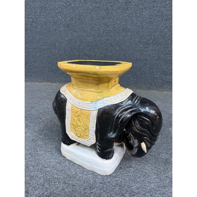 Chinese glazed ceramic elephant garden seat featuring a caparisoned elephant with a richly decorated saddle and raised...