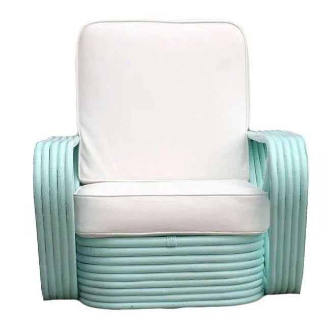 Five-strand square pretzel arm rattan chairs with stacked bases in the style of Paul Frankl. Both chairs have been...