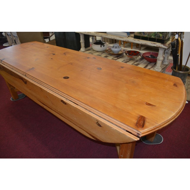 This is a huge & very heavy/thick pine dining table. Someone said it is possibly an Irish wake table. It has wooden rods...