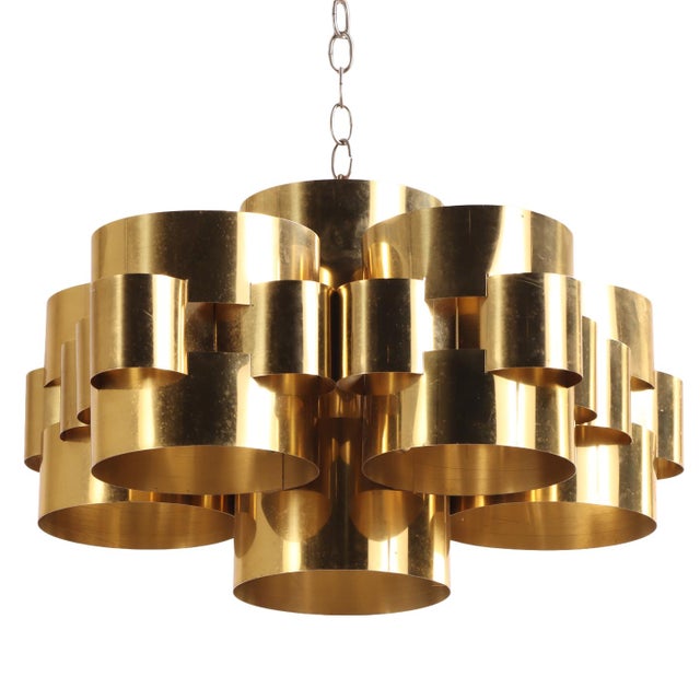 Executed in polished brass, this sculptural chandelier exemplifies the bold organic modernism and distinctive handcrafted...