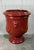 A monumental French Anduze style terracotta garden urn, richly glazed in a deep, lustrous red. The classical form features...