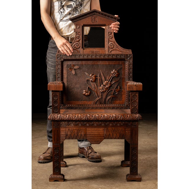 An exceptional Victorian open-back armchair constructed from mahogany and dated 1880. Its tall, architectural profile is...