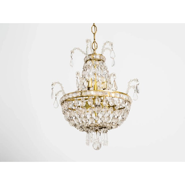 Elegant French style crystal and brass chandelier.