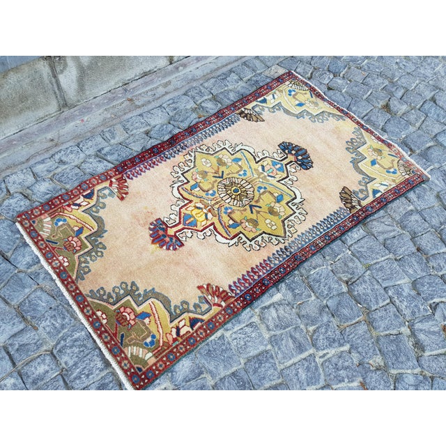 Oversized center medallion with intricate serrated contour atop a predominantly open field and opposing ends of...