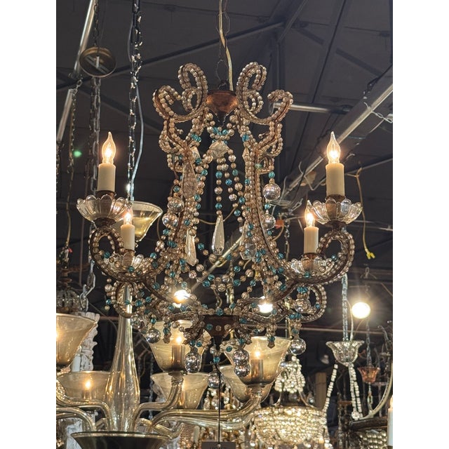 The Vintage Italian Beaded Chandelier is a beautifully crafted decorative collectible that adds a touch of elegance to any...