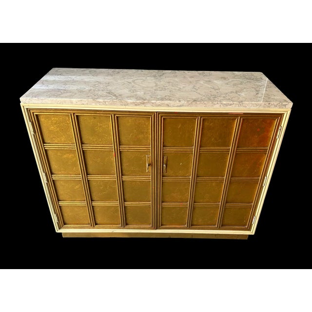 A mid-century, Oriental style, gilt wood cabinet, topped with a beautifully striated marble top. Made by Medallion...