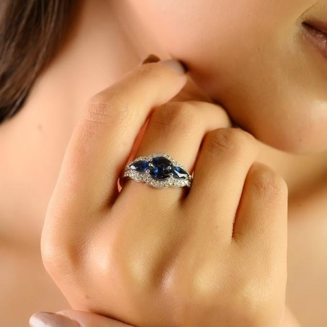 This exquisite ring features four marquise-cut blue sapphires with a combined weight of 1.62 carats, beautifully set in...