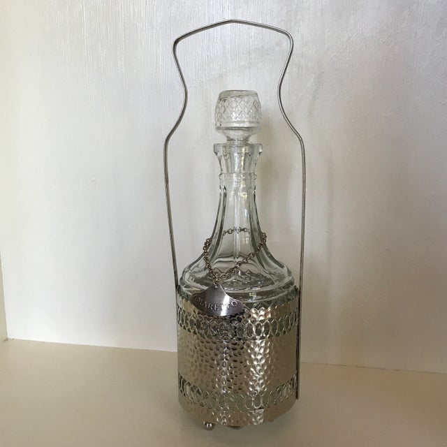 Never used found in original packaging this decanter has a hammered silver plated caddie with handle. It will hold a 1/5...