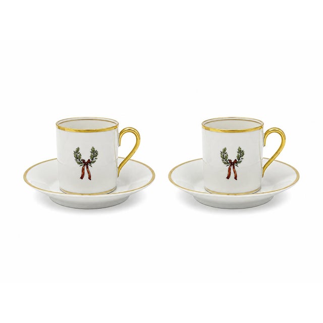 Pair of vintage porcelain demitasse cups and saucers decorated with finely detailed equestrian jockeys on horseback....