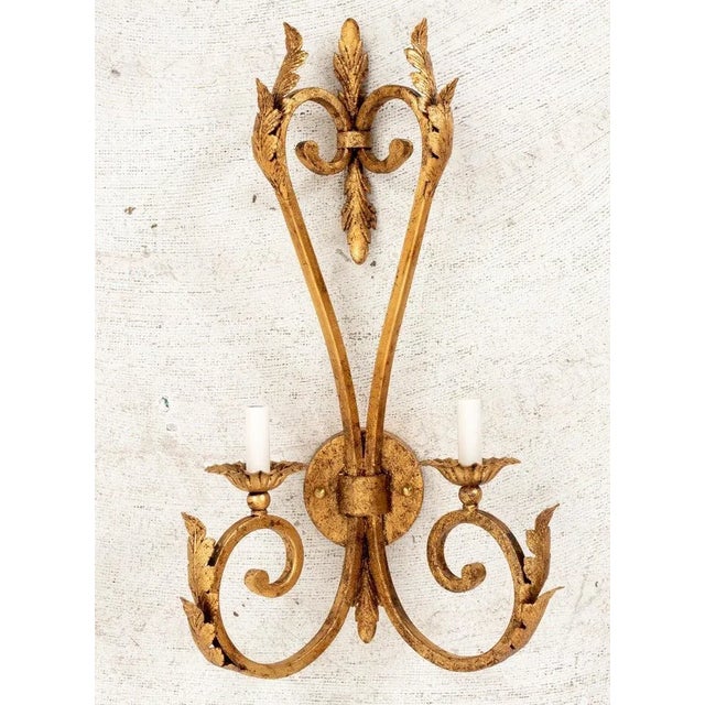 Pair of Large Scale Hollywood Regency gilt iron sconces with two arms each. Sconces are handmade in Miami Lakes, FL by...