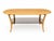A beautiful Ercol model 1063 oval coffee table, featuring a blonde wood finish, elegant curved legs and a smoked glass...