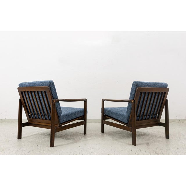 A pair of club chairs "type b7522," designed by zenon bączyk and produced in poland in the 1960s, exemplifies the...