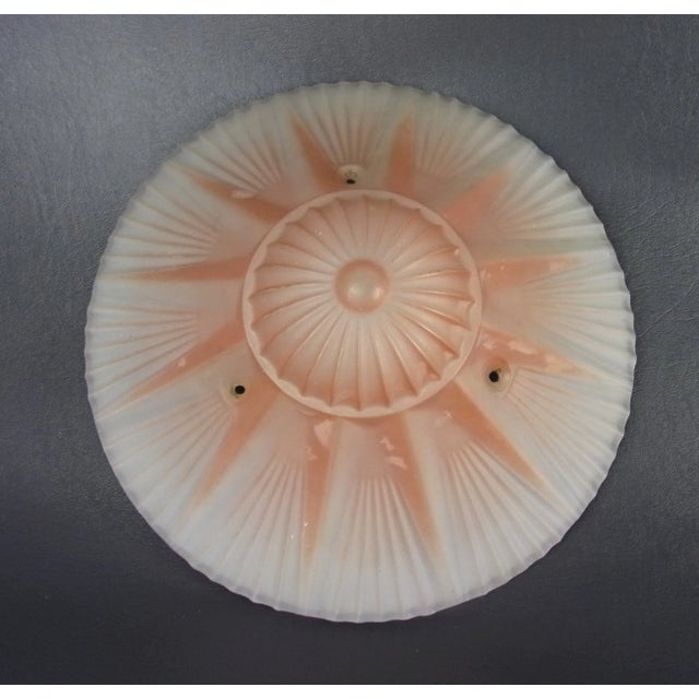 . Antique light shade . Art Deco 1920s . Done in a pale pink, frosted glass . Featuring a classic Art Deco, sunburst...