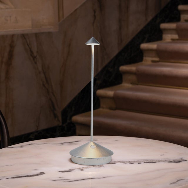 Pina Pro Battery-operated and rechargeable portable table lamp. The lamp features dimming touch control and has 3-CCT...