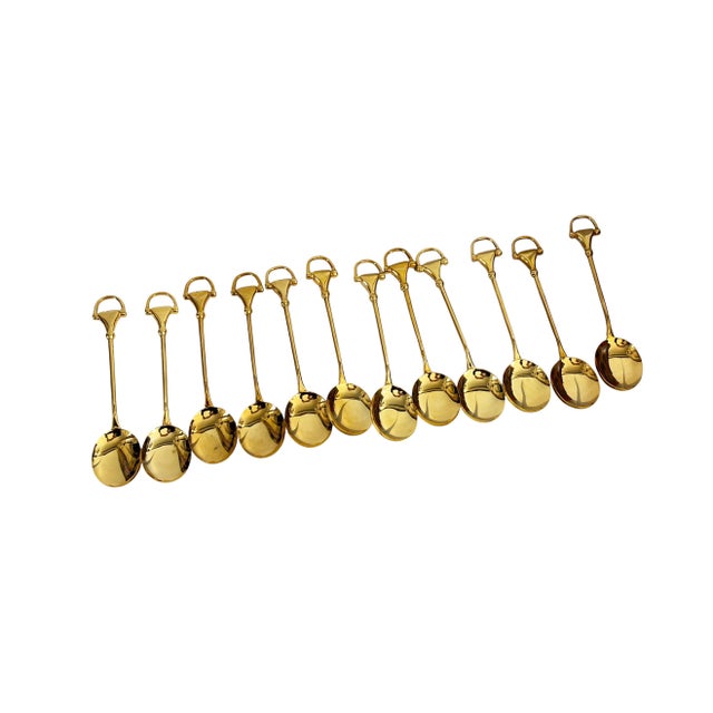 Superb set of 12 Gucci gold-plated demitasse spoons with iconic horsebit-style handles. Each spoon features the signature...