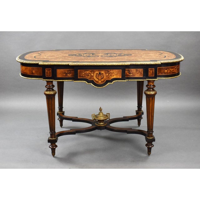 A good quality 19th century marquetry centre table, having ormolu mounts throughout, the shaped top with concentric...