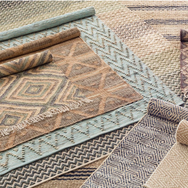 With its beautifully distressed look and rustic crisscross pattern in shades of earthy tones, this woven jute rug is a...