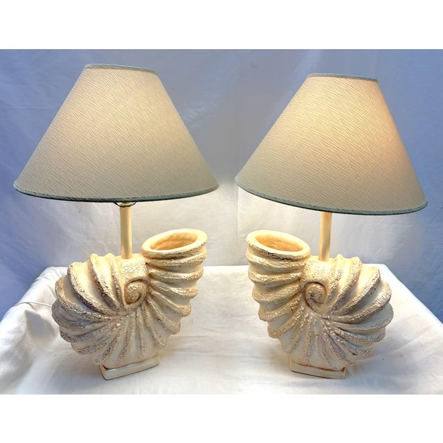 Fun vintage pair of Palm Beach Chic table lamps from 1980's. They are made of ceramic and shaped like large nautilus...