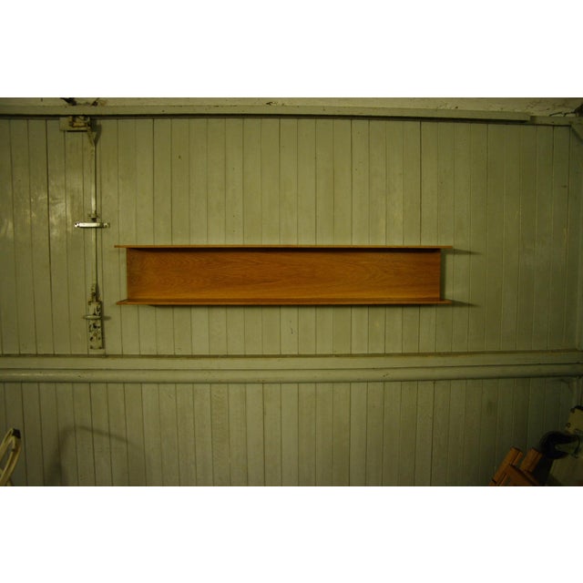 This U-shaped hanging shelf was designed by American designer Walter Witz and marketed by the German company Wilhelm Renz...