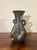 A classic American studio raku vase by renowned ceramist Tony Evans. This sculptural vessel features a traditional bulbous...