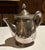 Vintage English silver-plated teapot in a classic rounded form with decorative rim detail. Features a matching monogram...