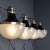 A superb set of four mid 20th century italian wall lights. These stylish lights showcase a blend of metal and black enamel...