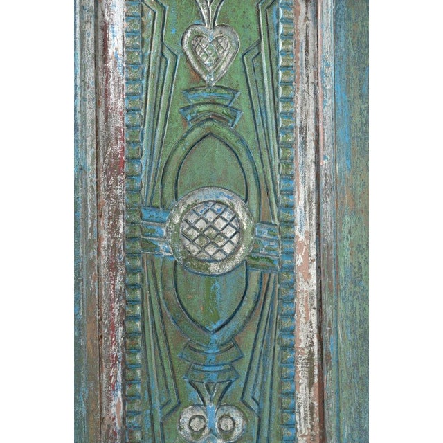 This Antique Indian Painted Teakwood Door is handcrafted from solid teakwood and adorned with layers of beautifully...