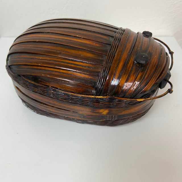 A beautifully crafted mid-century bamboo tiffin basket, handwoven by Chinese artisans in Taiwan during the Republic of...