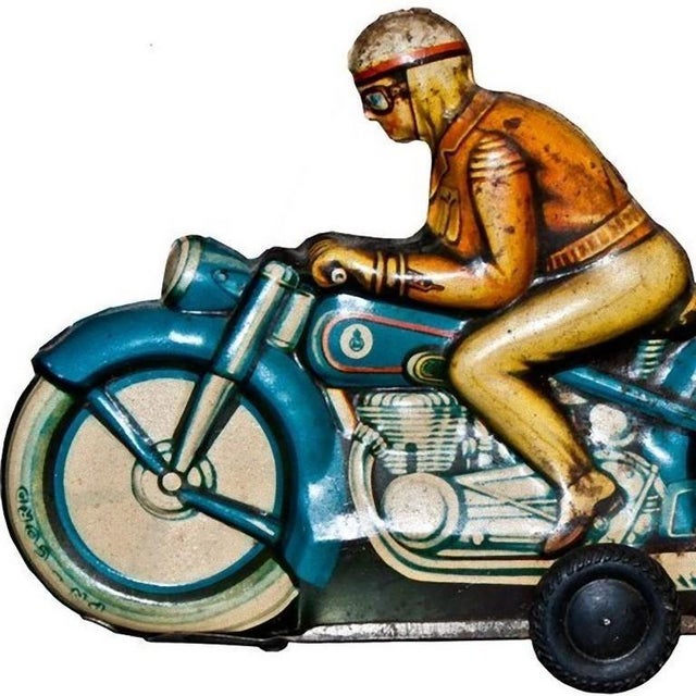 This friction motorcyclist is a vintage tin toy. Vintage friction tin toy representing a motorcyclist on his blue bike....