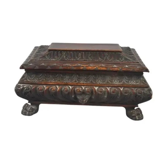 19th century Italian wooden carved casket box in the baroque style. Features gothic faces and lions paw feet. Can be used...