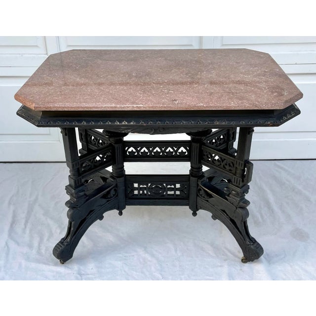 Here is an incredible table featuring an intricate carved wood base with a raspberry pink marble top! The base is really...
