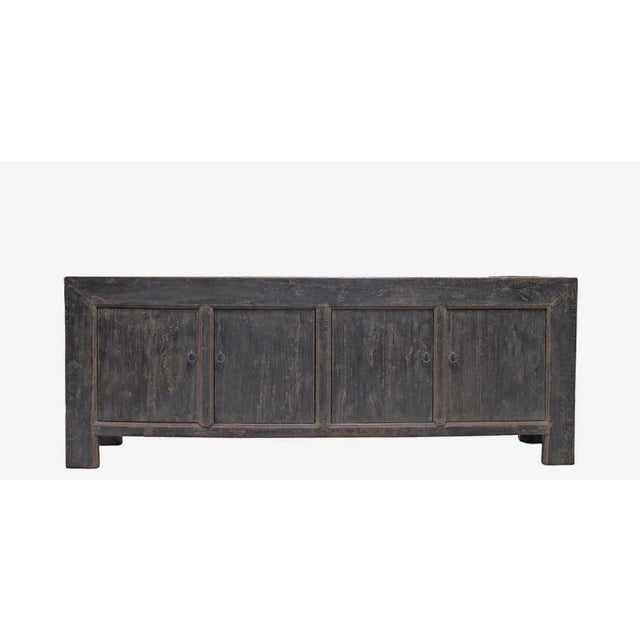 This vintage sideboard is made from reclaimed solid wood featuring a weathered, dark charcoal brown finish with rustic...