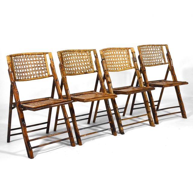 This sweet set of four folding side chairs are crafted of bamboo and cane. The architectural quality of the design...