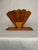 A beveled rectangular base holds a splayed arched blade fan to comprise the sides of this napkin holder. A small wood...