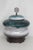 This gorgeous Large Lidded Jar is made out of ceramic. This vibrant jar presents a tapered and rounded silhouette, and was...