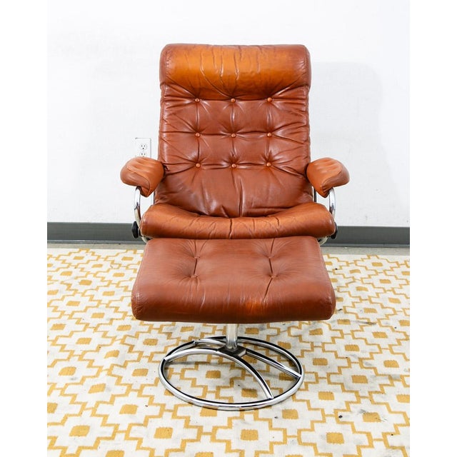 Beautiful Stressless Ekornes Chair and ottoman in the rare chrome frame and red leather upholstery. It swivels and...