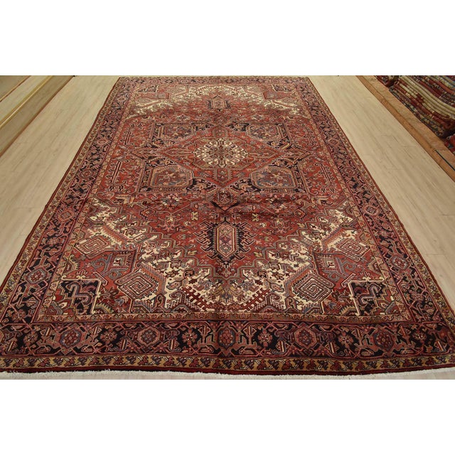 An authentic vintage traditional tribal Heriz rug hand-knotted with fine wool and natural dyes. This rug features a...