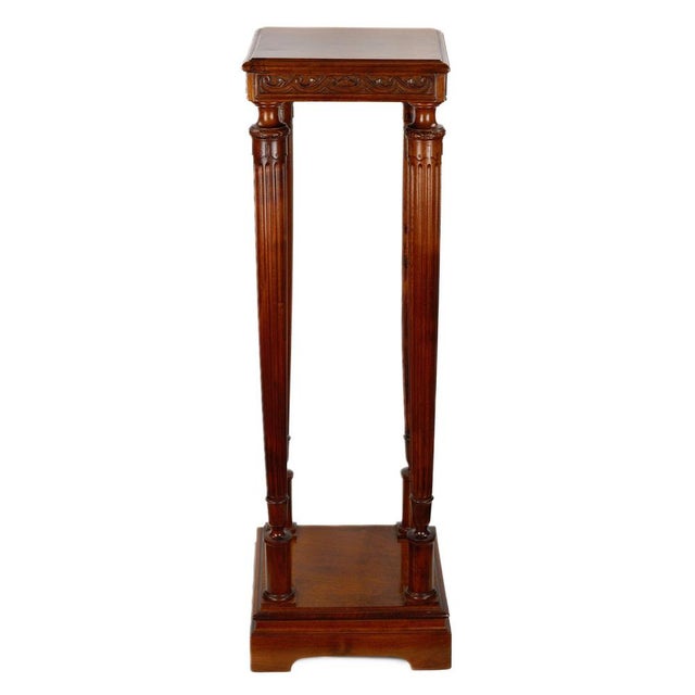 Solid walnut wooden console on four columns with intricate art deco bases and pedestal. Carries a square panel with a wave...