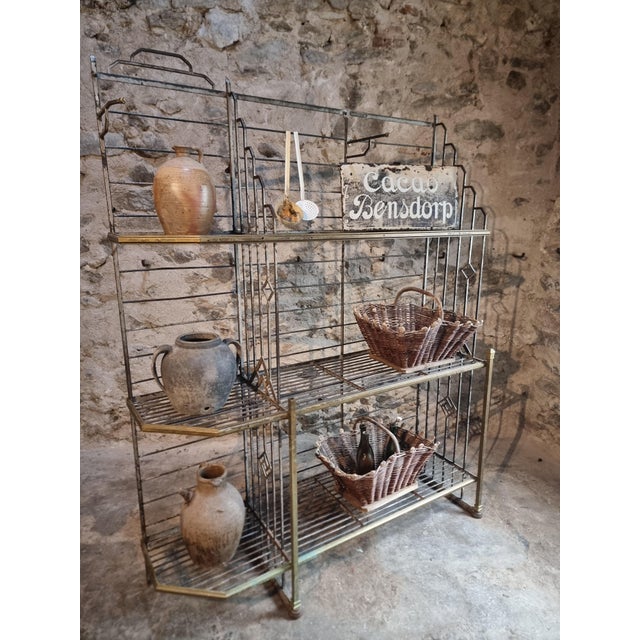 This rare antique industrial shelving unit was produced by Dubois Constructeur in Lyon, as indicated by the original...