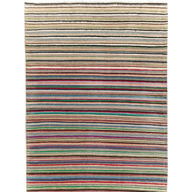 This mid-20th-century Turkish Anatolian long runner presents a continuous arrangement of narrow horizontal stripes...