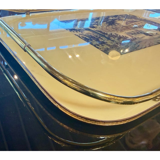 Elegant vintage Italian serving tray featuring a cream-colored surface with a detailed pastoral villa scene at the center....