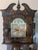 This is a mid-20th-century Chinoiserie black lacquer grandfather clock, a decorative style frequently imported by makers...