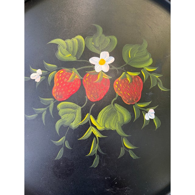 Vintage round, hand painted strawberry tole serving tray. Tray measures 13" in diameter by 1 1/4" in height. The back has...