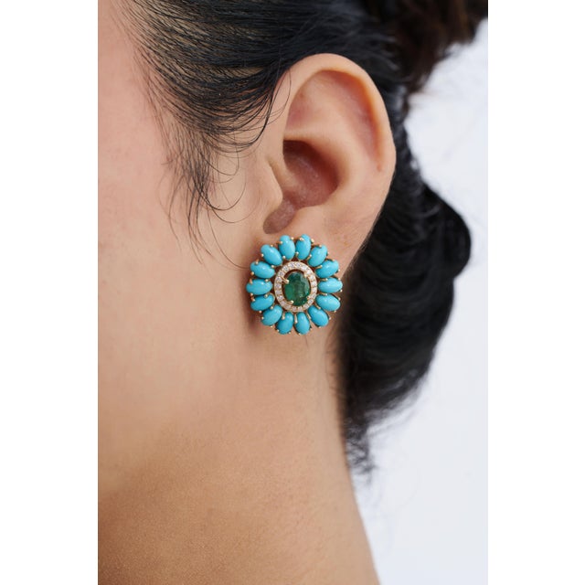 These flower cluster stud earrings feature 7.07 carats of vibrant emeralds and turquoise cabochons, set in 14k yellow...