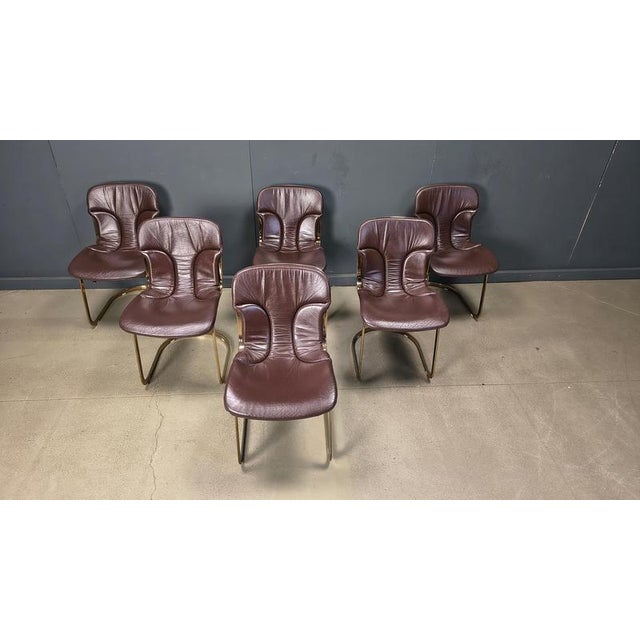 Set of 6 elegant dining chairs by Cidue. The chairs have a beautifully shaped chrome frame and come with the original...